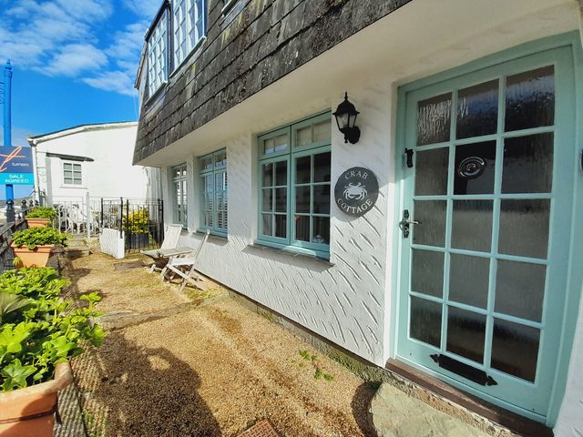 An outdoor view of Crab Cottage with a garden area in Ilfracombe