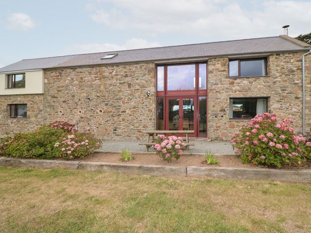 An outdoor area with stone walls and a seating area at The Owl's Hoot in Tacumshane, County Wexford