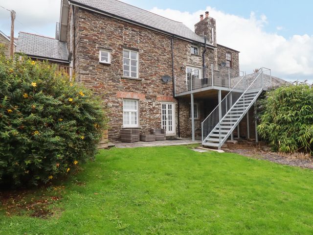 An outdoor view of a building with stairs and garden at Tower House in Boscastle