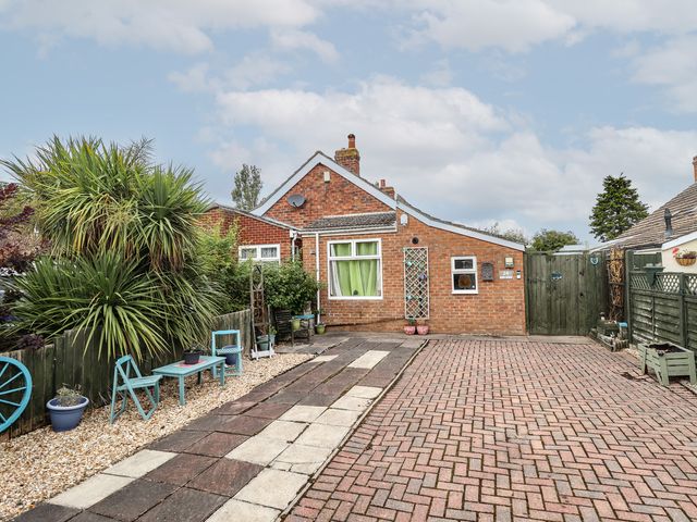 An outdoor area with a house and plants at Herby's Retreat Sutton-On-Sea