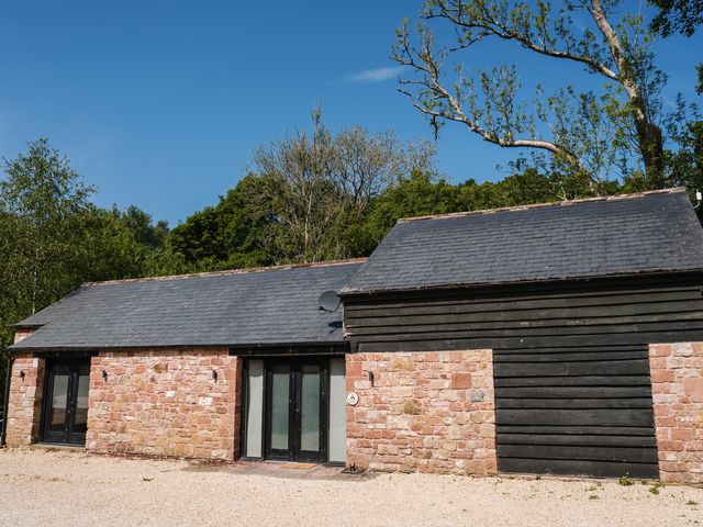 A building featuring a stone wall and slate roof at The Heronry, Longtown