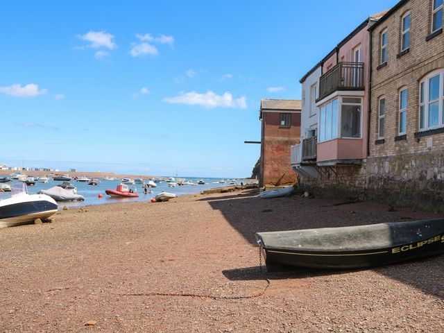 A view of boats at the shore by a building at The Dolphins in Shaldon