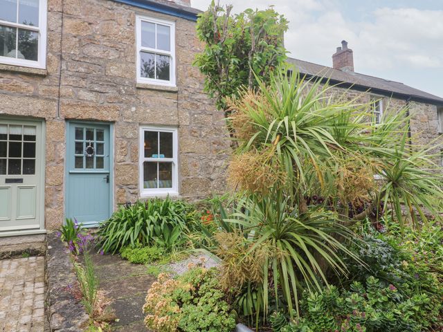 A cottage exterior with plants and stone wall at 2 The Cottages Ludgvan