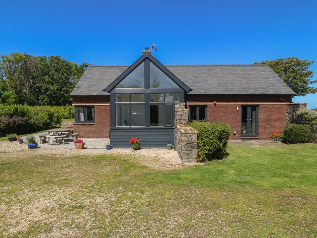 A house with garden furniture and flower pots at Tyn Morfa Llangwnnadl near Aberdaron