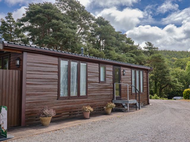 A cottage exterior with steps and planters at The Cabin at East Hill Pride, Four Elms Hill Nr. Sidmouth