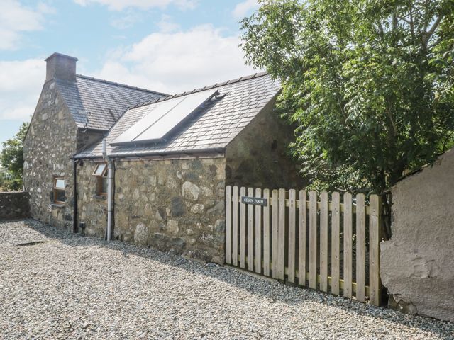 A house with solar panels and a gate at Cegin Foch in Chwilog