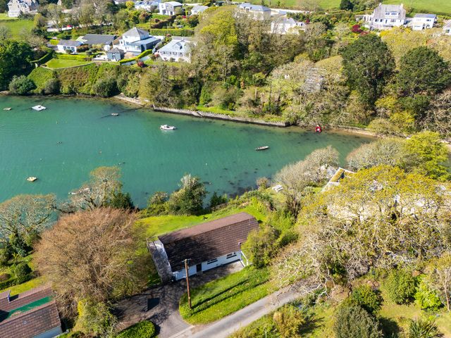 An aerial view of houses and water in Feock near Carnon Downs
