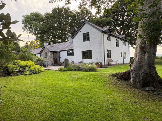 A house with a garden and tree at Garth Cottage in Groes near Denbigh