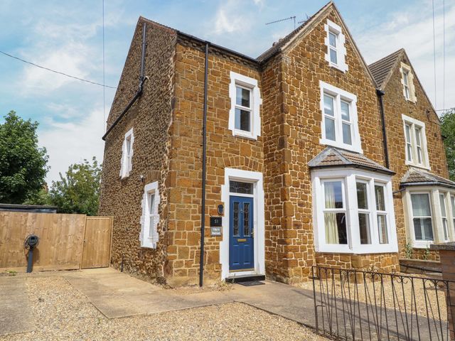 A house exterior with a blue door and windows at Tilly's Retreat in Hunstanton