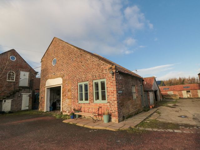 A brick building with windows and a door at The Old Milk House Potto near Hutton Rudby