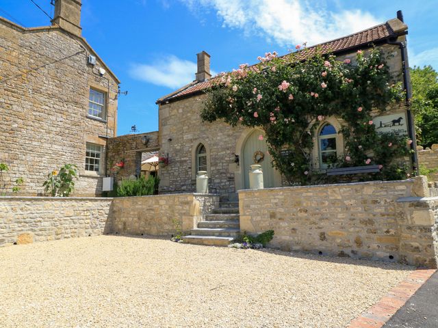 An outdoor view of a stone cottage with a garden at Cider Press Cottage in Priston Village, Bath