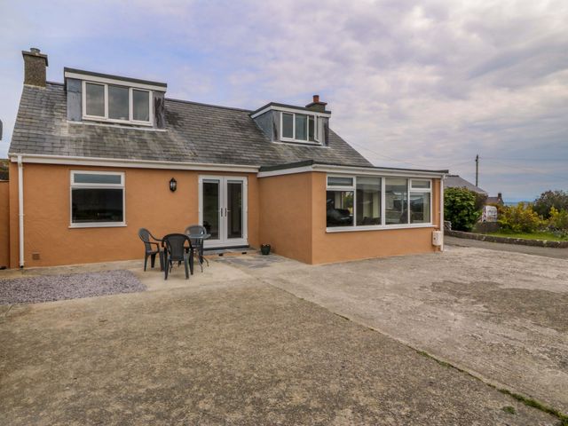 An outdoor view of a house with seating at Dalar Deg in Aberdaron