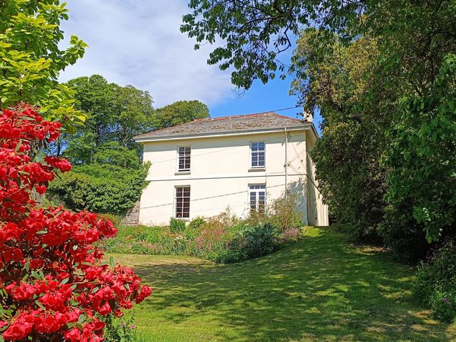 A house with a garden and flowers at The Patio Flat in Bodmin Moor