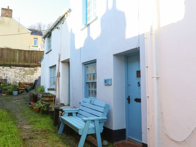 An outdoor area with a bench and door at Willets Cottage in Appledore