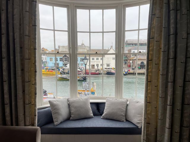 A window with cushions overlooking the harbor at Safe Harbour Brewers Quay harbour