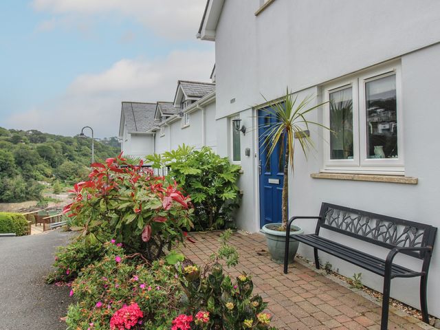 A house entrance with a bench and plants at 16 Bolt Head in Salcombe