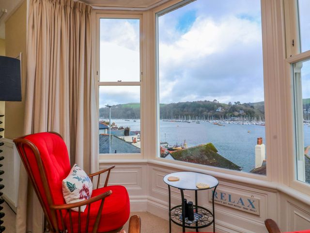 A living room with a window view of the lake and boats at 3 Dartview Dartmouth