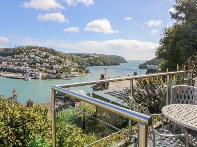 A balcony with seating overlooking the water at Dart Views in Dartmouth
