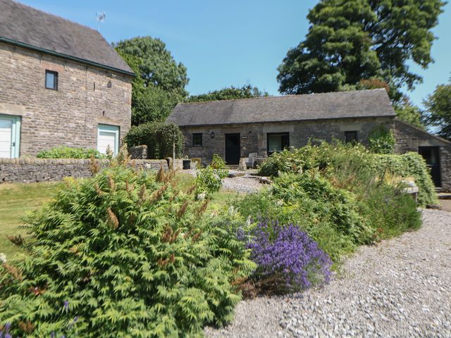 An outdoor area with stone houses and plants at Slade Tops in Ilam