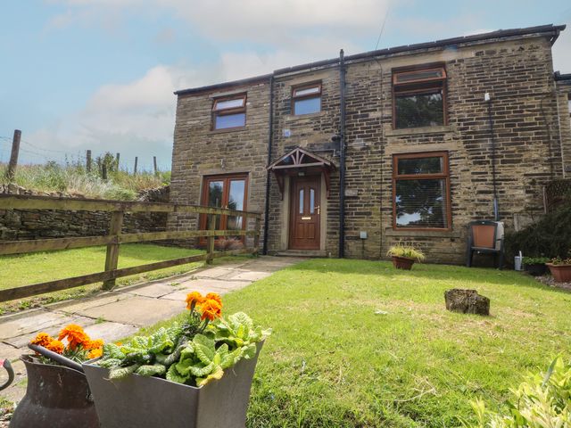A house with a front door and flowers in pots at Moscow Mews in Thornton