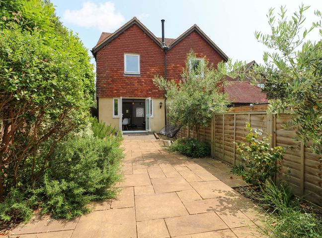 A house with a garden and pathway at 2A The Mews Langstone