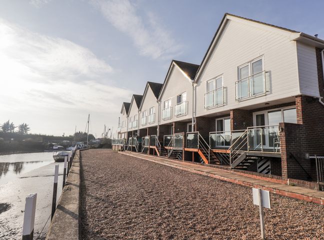 A row of houses with balconies along a waterfront at 3 Tidal in Rye