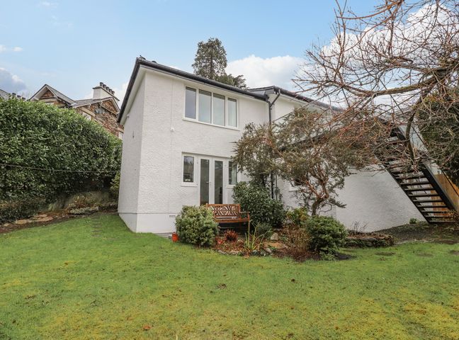 A white two-story house with garden and metal staircase at Hillhead in Ambleside
