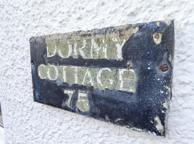 A sign displaying Dormy Cottage 76 located outdoors at Dormy Cottage Skegness