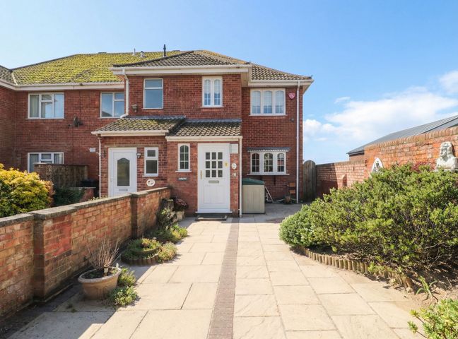 A house with a front door and pathway at Breaking Waves in Burnham-On-Sea