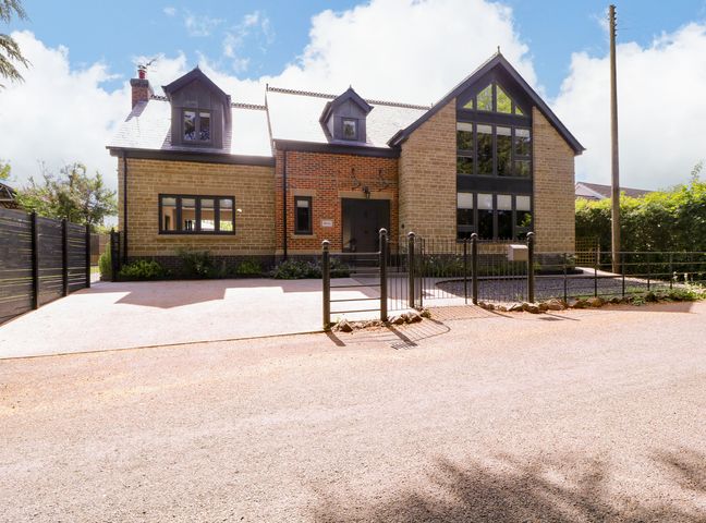 A house with a fence and driveway at Thornbury, Barnard's Green, Malvern