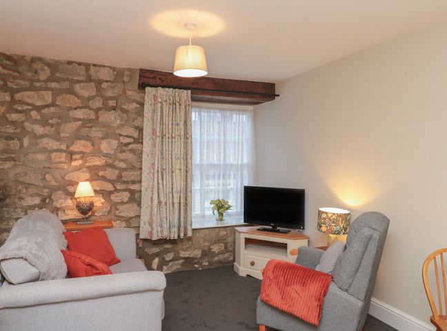 A living room with a sofa and television at Beck View