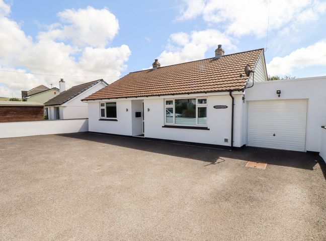 A detached bungalow with a tiled roof driveway and attached garage at Summerhayes in Park Bottom