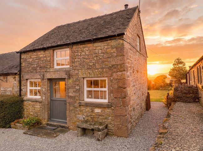 A stone house with front door and windows at The Dairy Middleton near Youlgreave