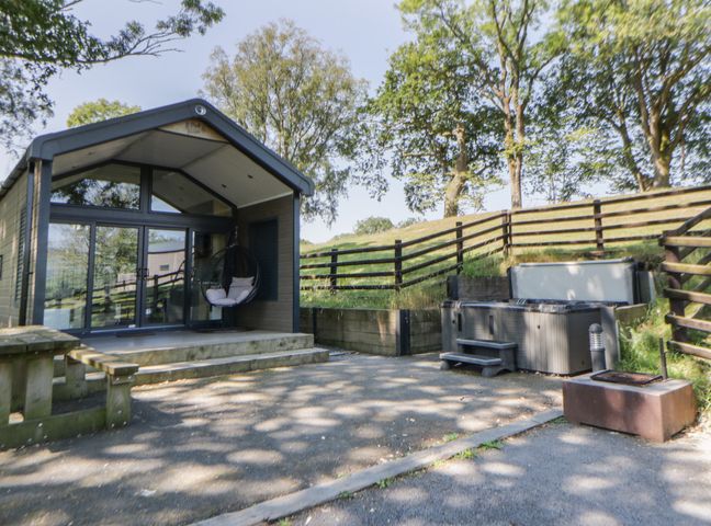 An outdoor area with a hot tub and hammock chair at Oak Tree View Nantmel near Rhayader