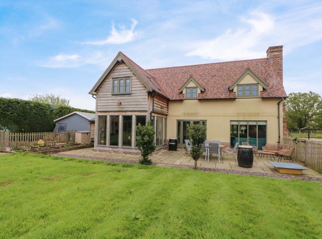 An outdoor area with a house and garden at Gayton Stables in Heswall