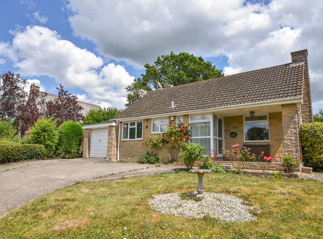 A bungalow with a garden and driveway in front at Byeways in Whitford