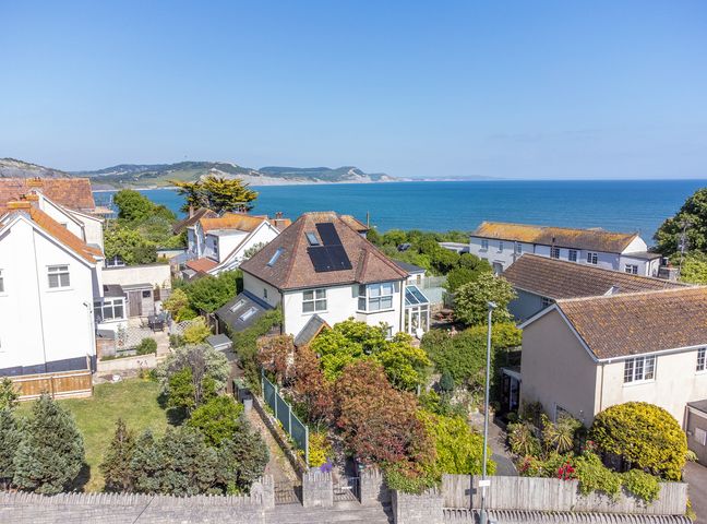 A residential area with houses gardens and a view of the sea at Hove To Lyme Regis