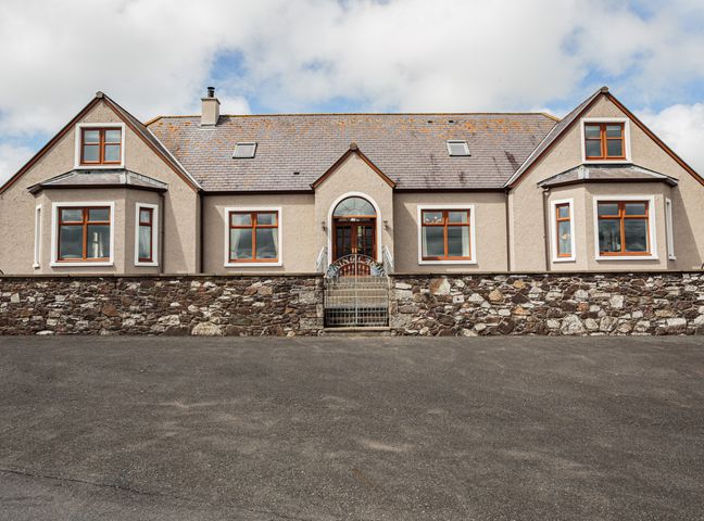 A stone and stucco house with a central gate and wooden framed windows at Kringlands in Kirkcolm