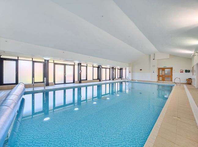 A swimming pool with a handrail at Marine Court Two Bedroom Second-floor Apartment 33 Littlehampton