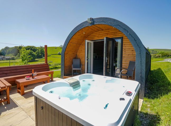 An outdoor area with a hot tub and seating at Beech in Ulverston