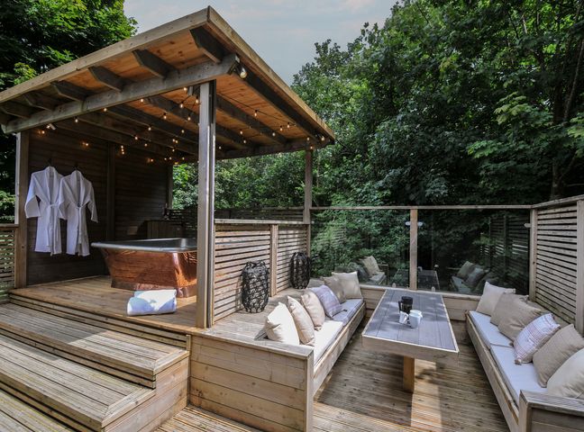 An outdoor spa area with a bath and seating at 24 Meadow Retreat Dobwalls
