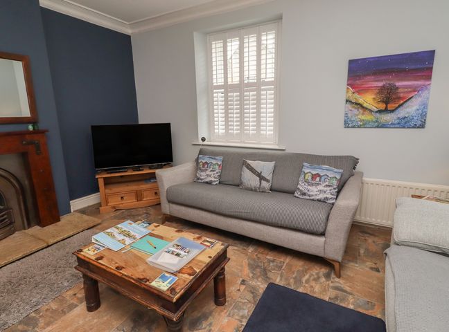 A living room with a television and sofa at Number Seventeen in Amble