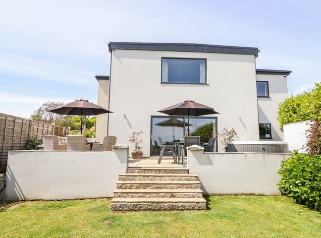 A house with a patio and garden at Bryn Mor in Benllech