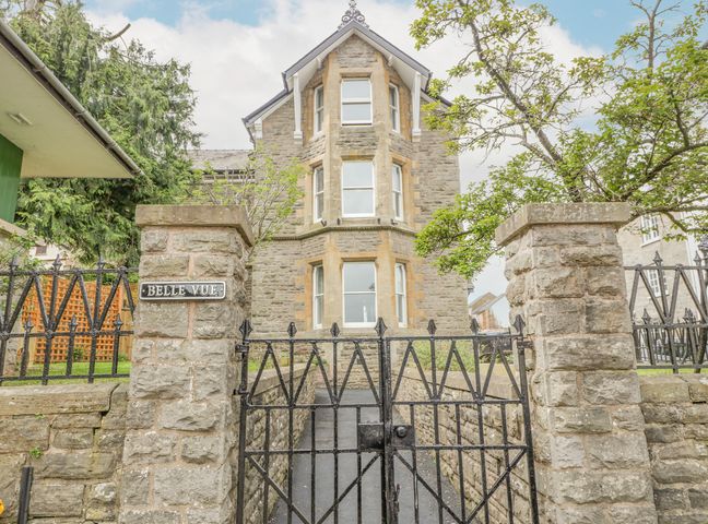 A stone building with a black metal gate and stone pillars in front at Belle Vue in Hay on Wye Herefordshire