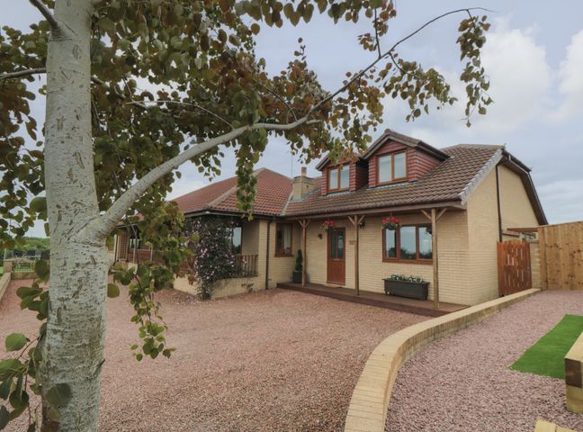 A detached house with tiled roof and gravel driveway at Greencroft in Saltburn-By-The-Sea