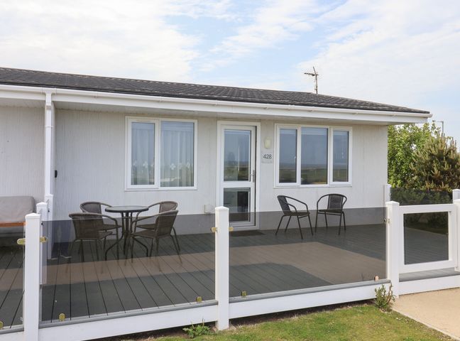 An outdoor area with a deck and seating at Bonny Bay in Wilsthorpe near Bridlington