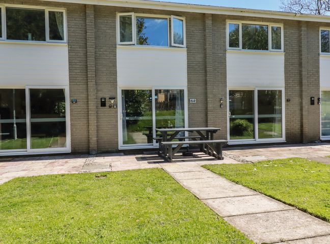 An outdoor area with buildings and a picnic table at 64 St Columb Nr Newquay
