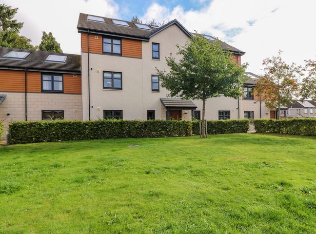 A residential building with multiple windows and two trees in front at 11 Ambleside Court in Banchory