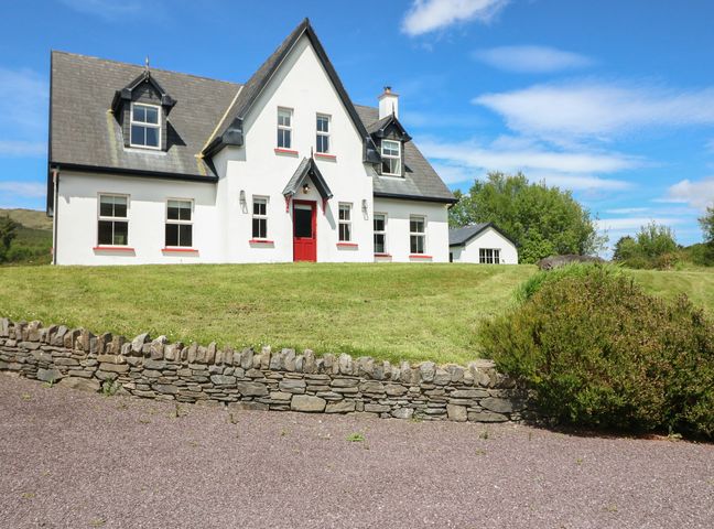 A house with a stone wall and garden at The Skating Rock Bunane near Kenmare, County Kerry