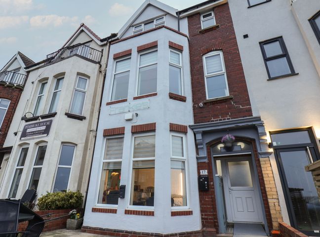 A row of terraced houses with bay windows and a front door in Bridlington